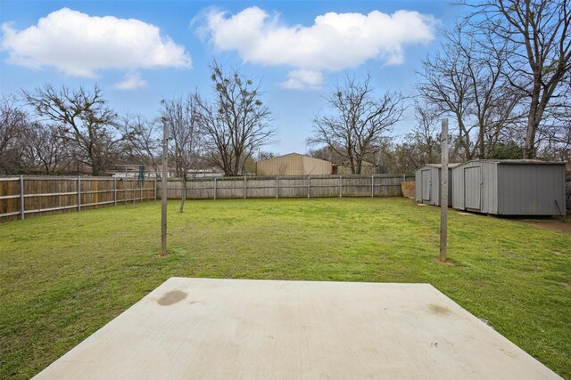 view of yard featuring a storage shed, a patio area, a fenced backyard, and an outdoor structure