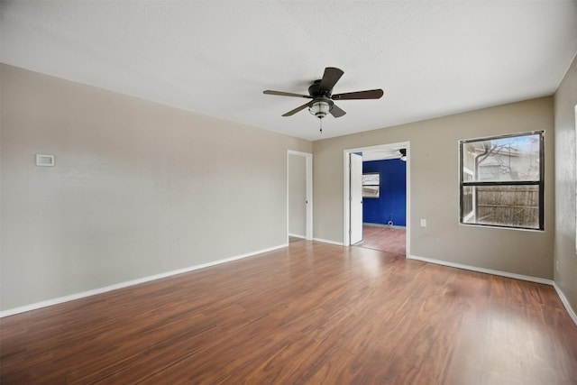 unfurnished room featuring ceiling fan, baseboards, and wood finished floors