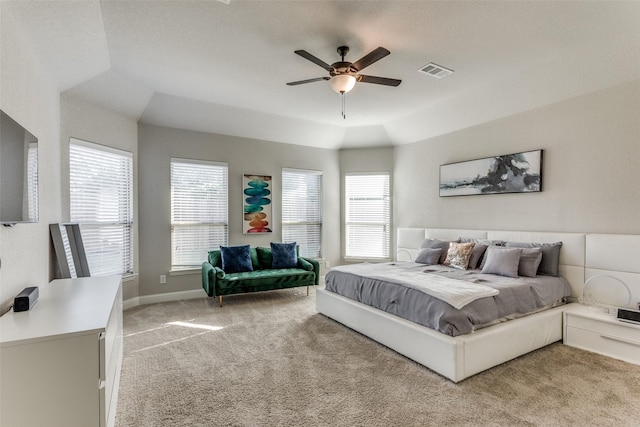 bedroom featuring visible vents, multiple windows, light colored carpet, and ceiling fan