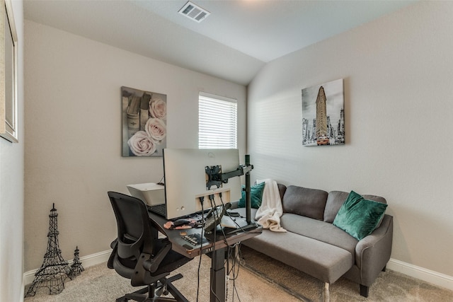 carpeted home office with visible vents, lofted ceiling, and baseboards