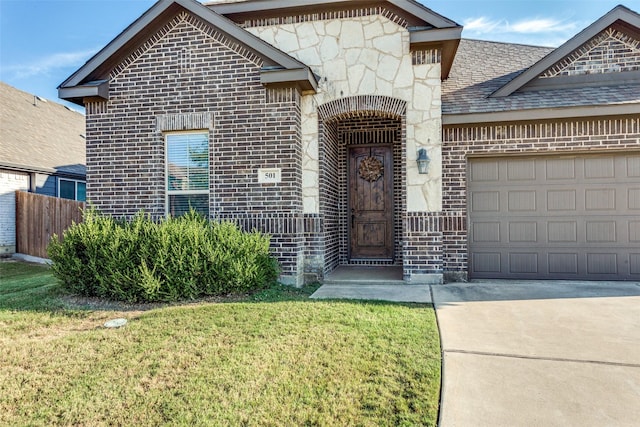 view of front of property featuring concrete driveway, a garage, brick siding, and stone siding