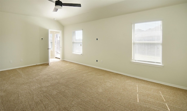 unfurnished room featuring vaulted ceiling, baseboards, carpet floors, and ceiling fan