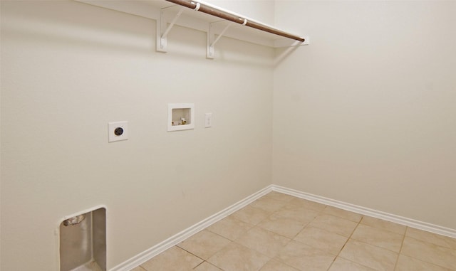 clothes washing area featuring electric dryer hookup, light tile patterned floors, baseboards, hookup for a washing machine, and laundry area