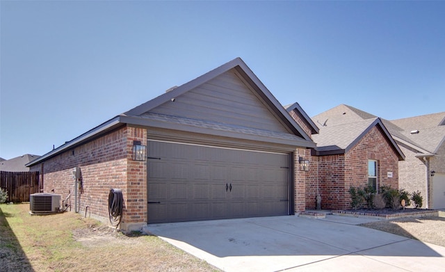 view of front facade featuring brick siding, fence, concrete driveway, cooling unit, and an attached garage