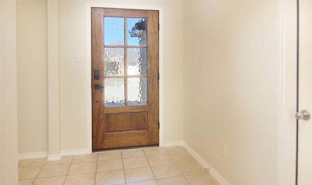 entryway with light tile patterned flooring and baseboards