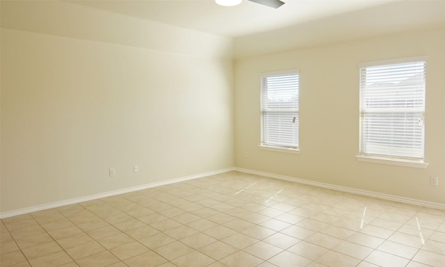 empty room featuring baseboards and ceiling fan