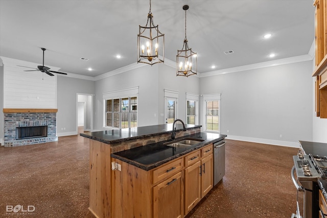 kitchen with open floor plan, appliances with stainless steel finishes, baseboards, and a sink