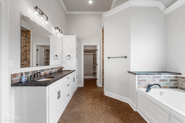 full bath with double vanity, a spacious closet, baseboards, and a sink