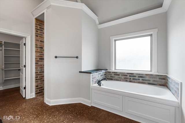 bathroom featuring a walk in closet, baseboards, a garden tub, and ornamental molding