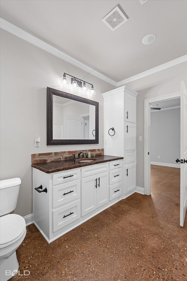 bathroom with visible vents, toilet, vanity, and baseboards