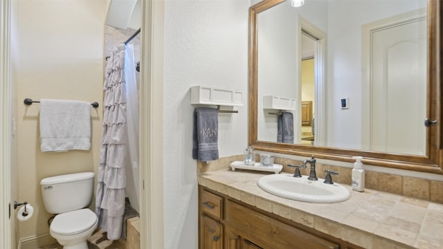 full bathroom with vanity, curtained shower, and toilet