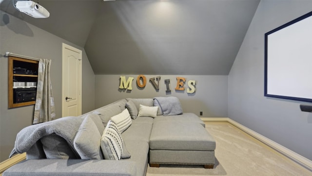 cinema room featuring lofted ceiling, baseboards, and carpet floors