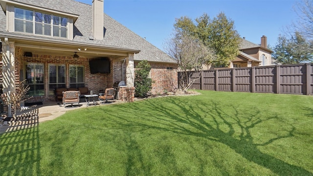 view of yard featuring ceiling fan, a patio, and a fenced backyard