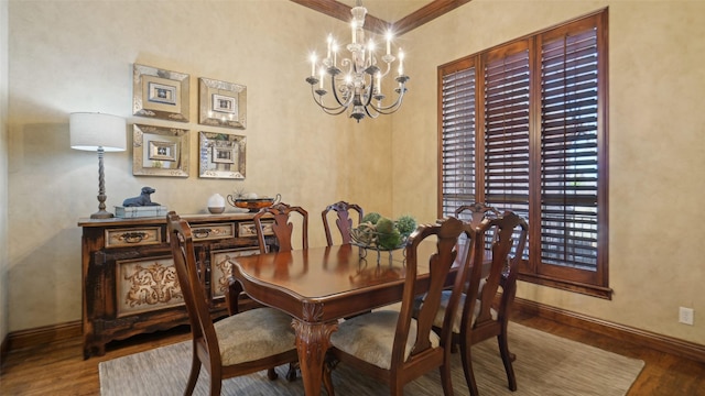 dining room featuring baseboards, an inviting chandelier, and wood finished floors