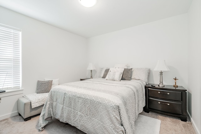 bedroom with baseboards and carpet flooring