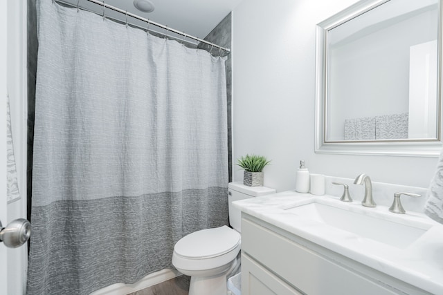 bathroom with a shower with shower curtain, toilet, and vanity