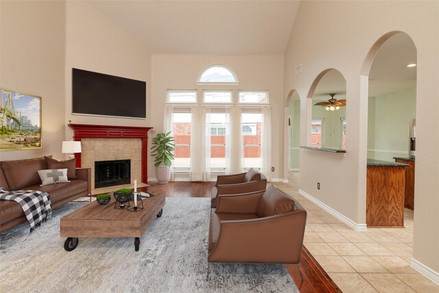 interior space with stairway, a high ceiling, baseboards, and wood finished floors