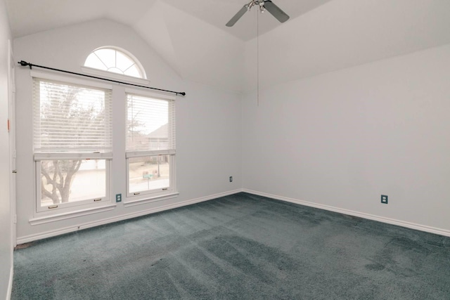 empty room featuring vaulted ceiling, baseboards, dark carpet, and ceiling fan