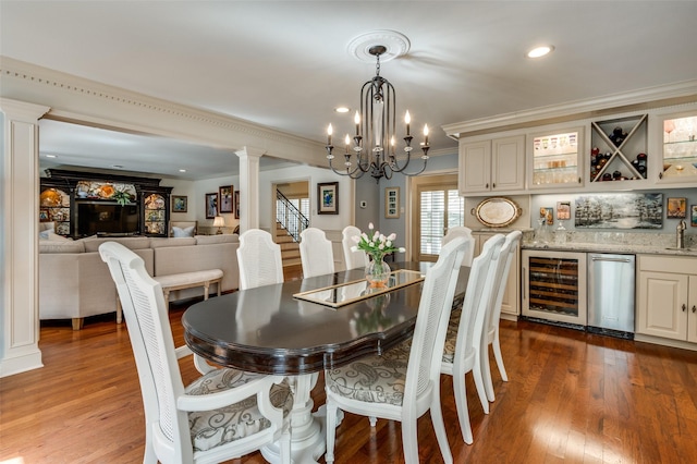 1905 Indian Creek Dr, Westover Hills, TX 76107 - dining area featuring beverage cooler, ornate columns, wet bar, crown molding, and a chandelier