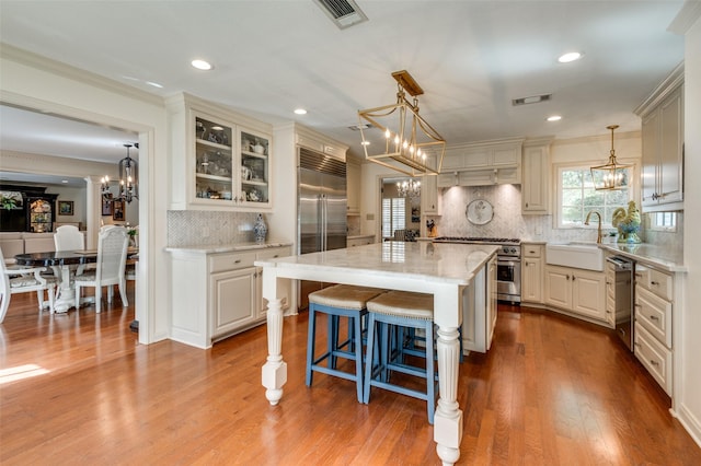 1905 Indian Creek Dr, Westover Hills, TX 76107 - kitchen featuring a sink, a chandelier, high end appliances, backsplash, and ornamental molding
