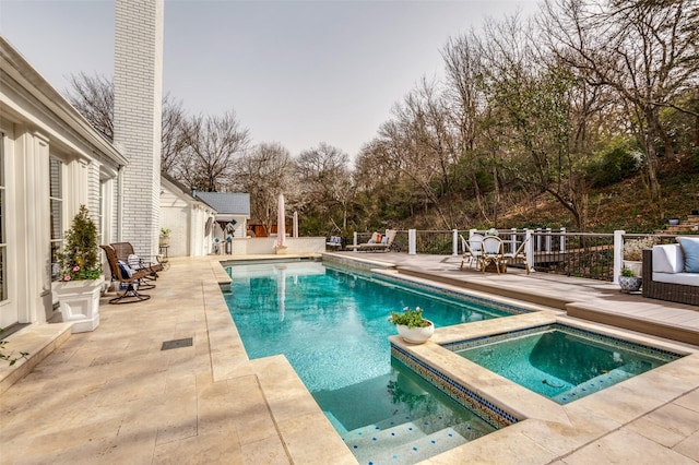 view of swimming pool featuring a deck, an in ground hot tub, a fenced in pool, and a patio area