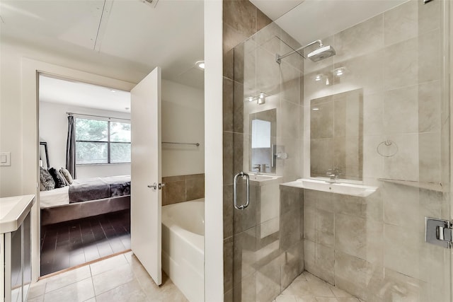 full bathroom featuring ensuite bath, a bath, tile patterned floors, and a shower stall