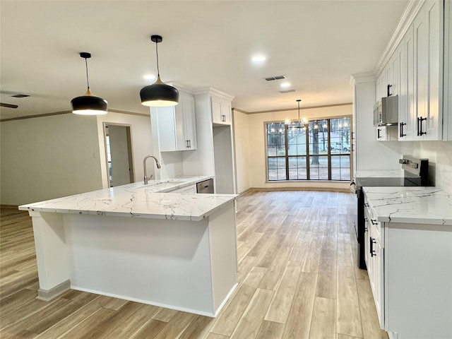 kitchen featuring light wood-style flooring, white cabinetry, stainless steel appliances, and a sink