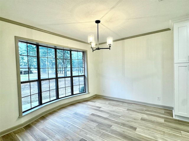 unfurnished dining area with light wood finished floors, baseboards, an inviting chandelier, and ornamental molding