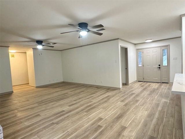 unfurnished living room with visible vents, baseboards, light wood-style floors, and crown molding