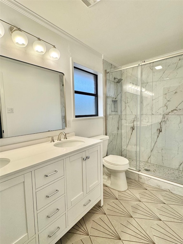 full bathroom featuring a marble finish shower, toilet, crown molding, and double vanity