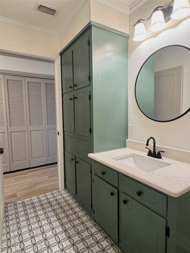 bathroom with vanity, visible vents, and ornamental molding