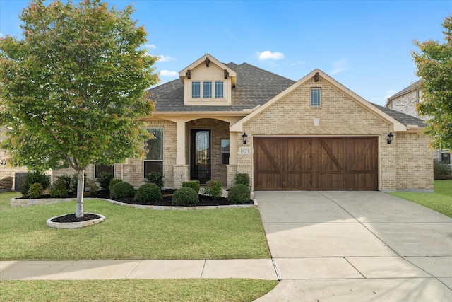 1621 Castleford Dr, Forney, TX 75126 - view of front facade with brick siding, an attached garage, and a front yard