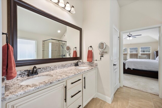 1621 Castleford Dr, Forney, TX 75126 - ensuite bathroom featuring double vanity, a stall shower, ceiling fan, and baseboards