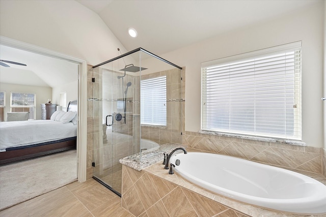 bathroom featuring lofted ceiling, a shower stall, a bath, and ensuite bathroom