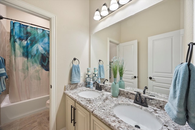 full bathroom with a sink, shower / tub combo with curtain, double vanity, and toilet