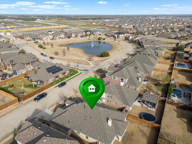 bird's eye view featuring a residential view and a water view