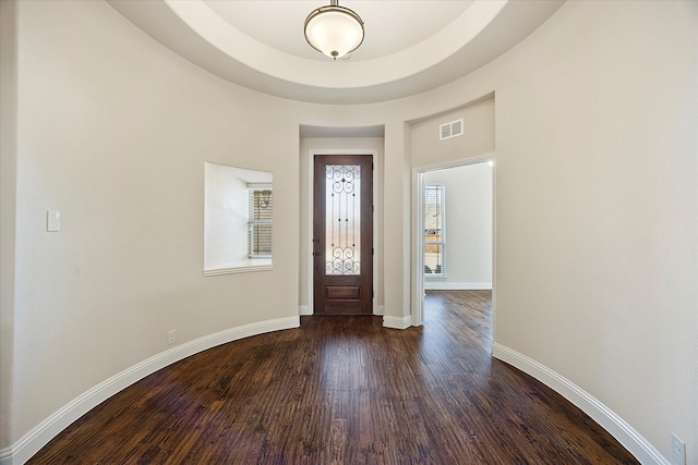 entrance foyer featuring visible vents, baseboards, and dark wood-style flooring