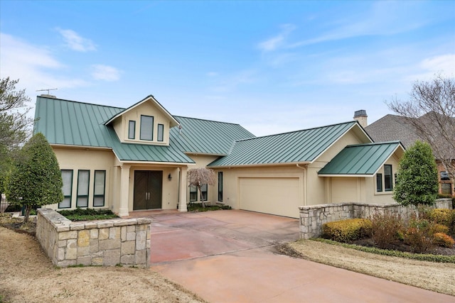 modern inspired farmhouse with a standing seam roof, metal roof, and stucco siding