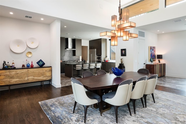 dining room with visible vents, baseboards, and wood finished floors