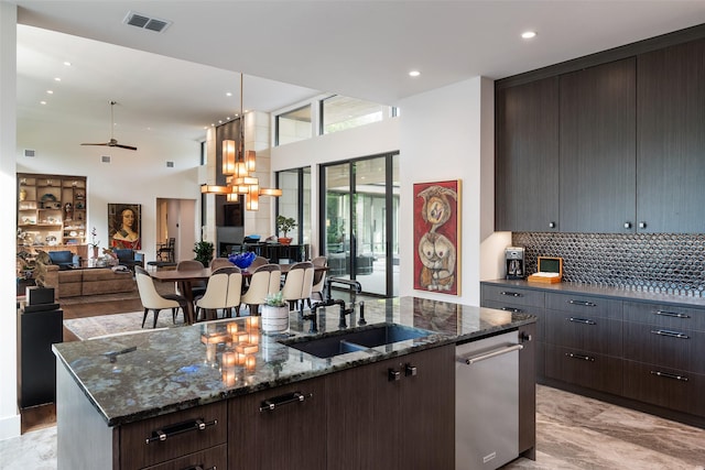 kitchen featuring visible vents, a kitchen island with sink, a sink, dishwasher, and open floor plan