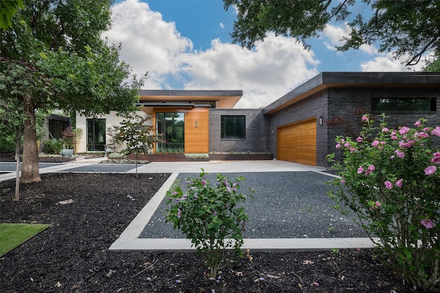 view of front of property featuring brick siding and an attached garage