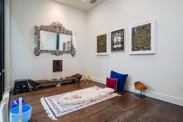 miscellaneous room with visible vents, wood finished floors, and baseboards