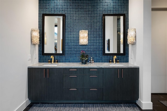 bathroom with a sink, tasteful backsplash, and double vanity