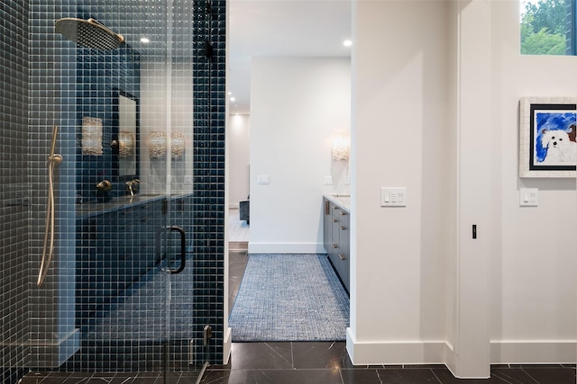 full bathroom with tile patterned floors, a shower stall, vanity, and baseboards