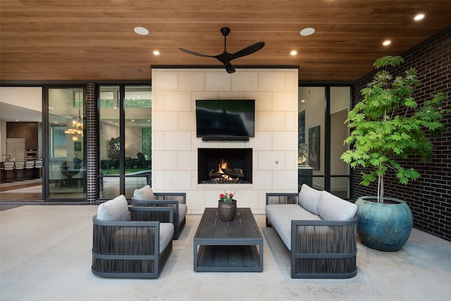 view of patio featuring an outdoor living space with a fireplace and ceiling fan