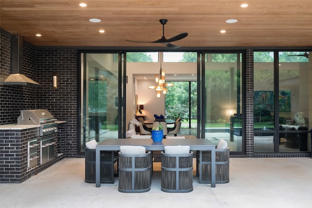 view of patio / terrace with ceiling fan, a grill, and an outdoor kitchen