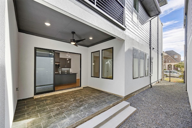 exterior space with a ceiling fan and fence