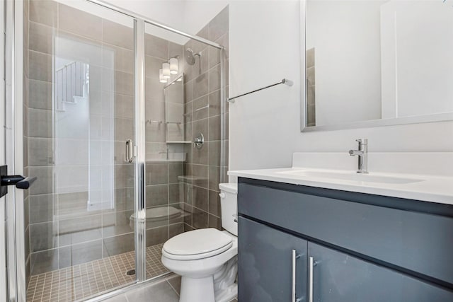 full bath featuring vanity, a shower stall, toilet, and tile patterned floors