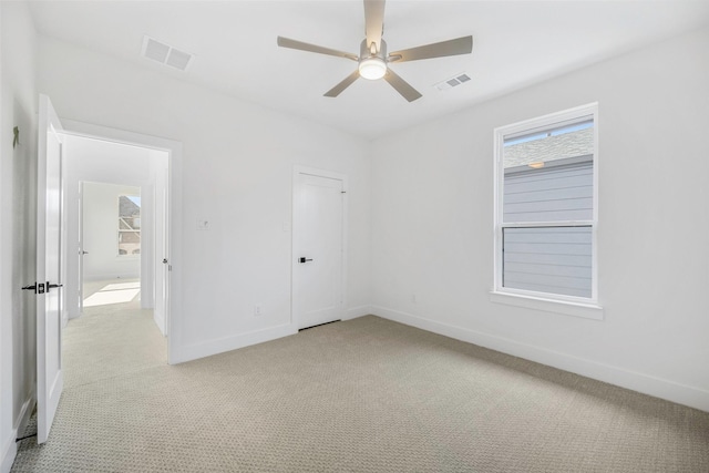 unfurnished bedroom with baseboards, visible vents, and light carpet