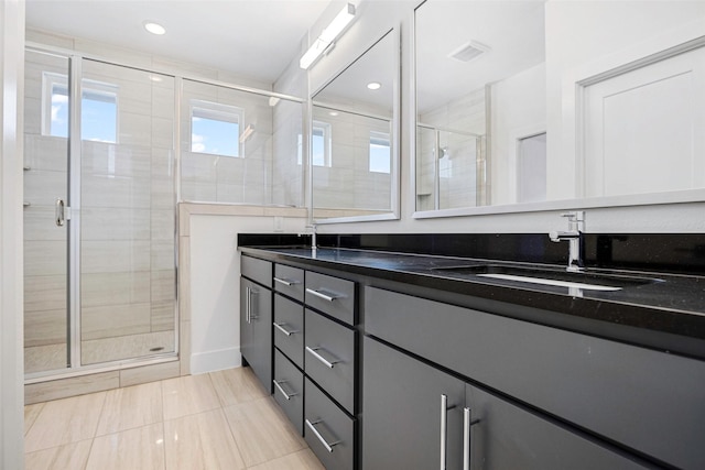 full bathroom featuring visible vents, a stall shower, a sink, recessed lighting, and double vanity